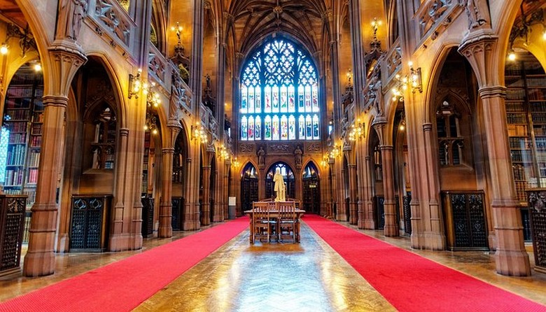 Phòng đọc chính của thư viện John Rylands với vòm đá và cửa kính màu